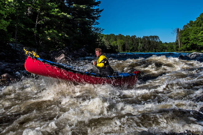 Nova Craft Prospector 15 - Lightweight Canadian Canoe being paddled through whitewater