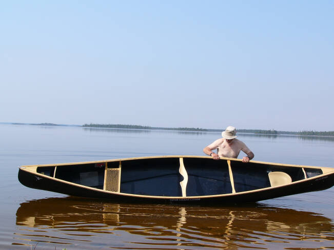 Nova Craft Prospector 16 Blue Steel with Ash Trim, being manuevered onto the water.