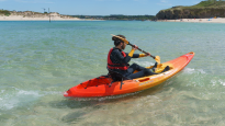 WaveSport Scooter X Lifestyle Image Paddling On Clear And Calm Coastal Waters